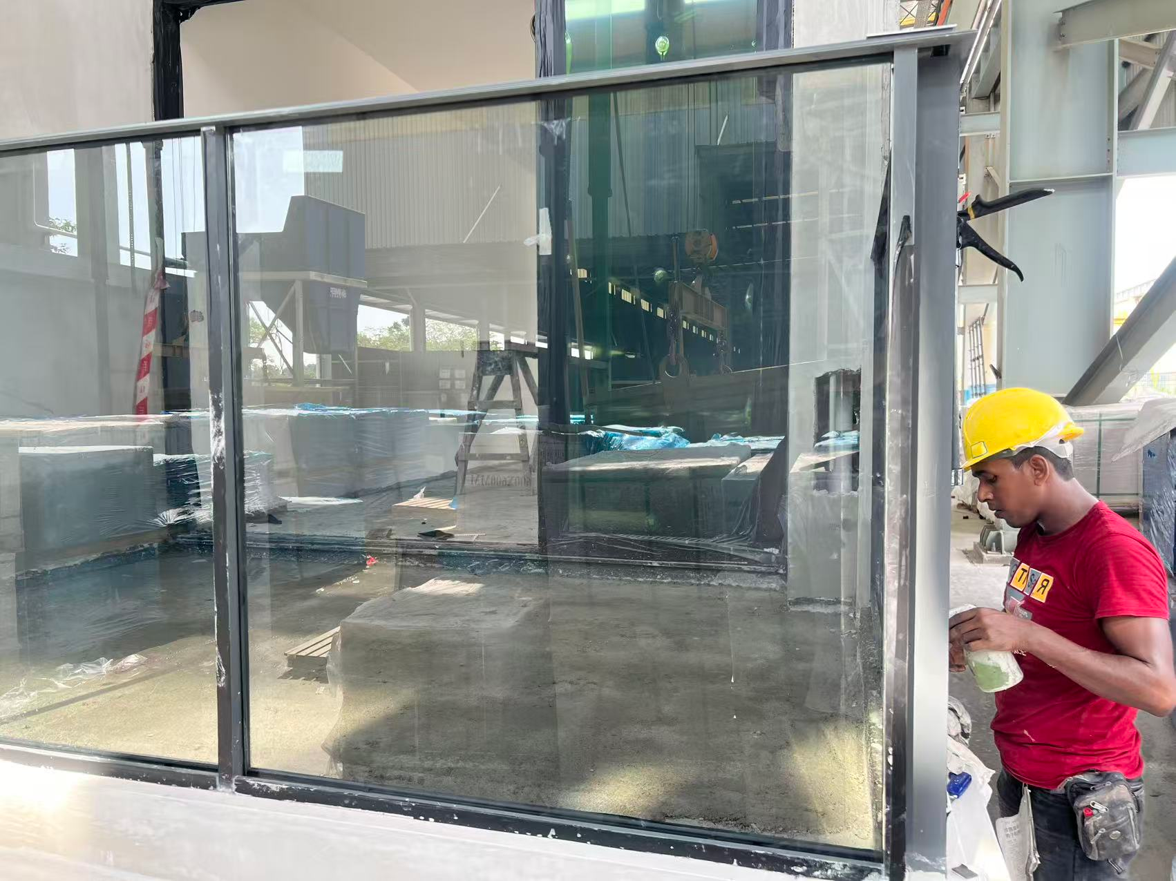 Close view of grey laminated balcony glass and aluminium framing during installation at PARKTOWN Residence.