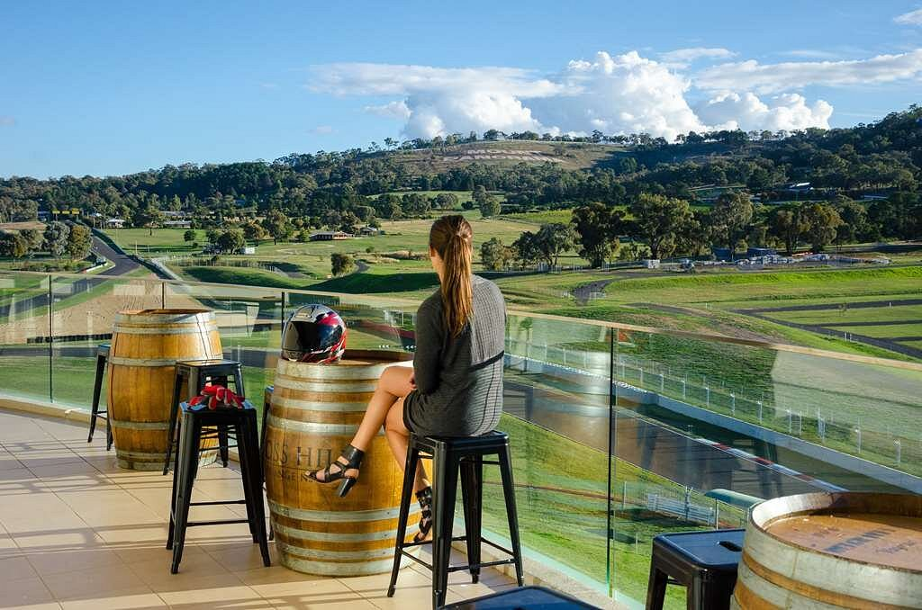 Transparent low-iron glass railing on the level-seven terrace overlooking the Mount Panorama motor racing circuit.