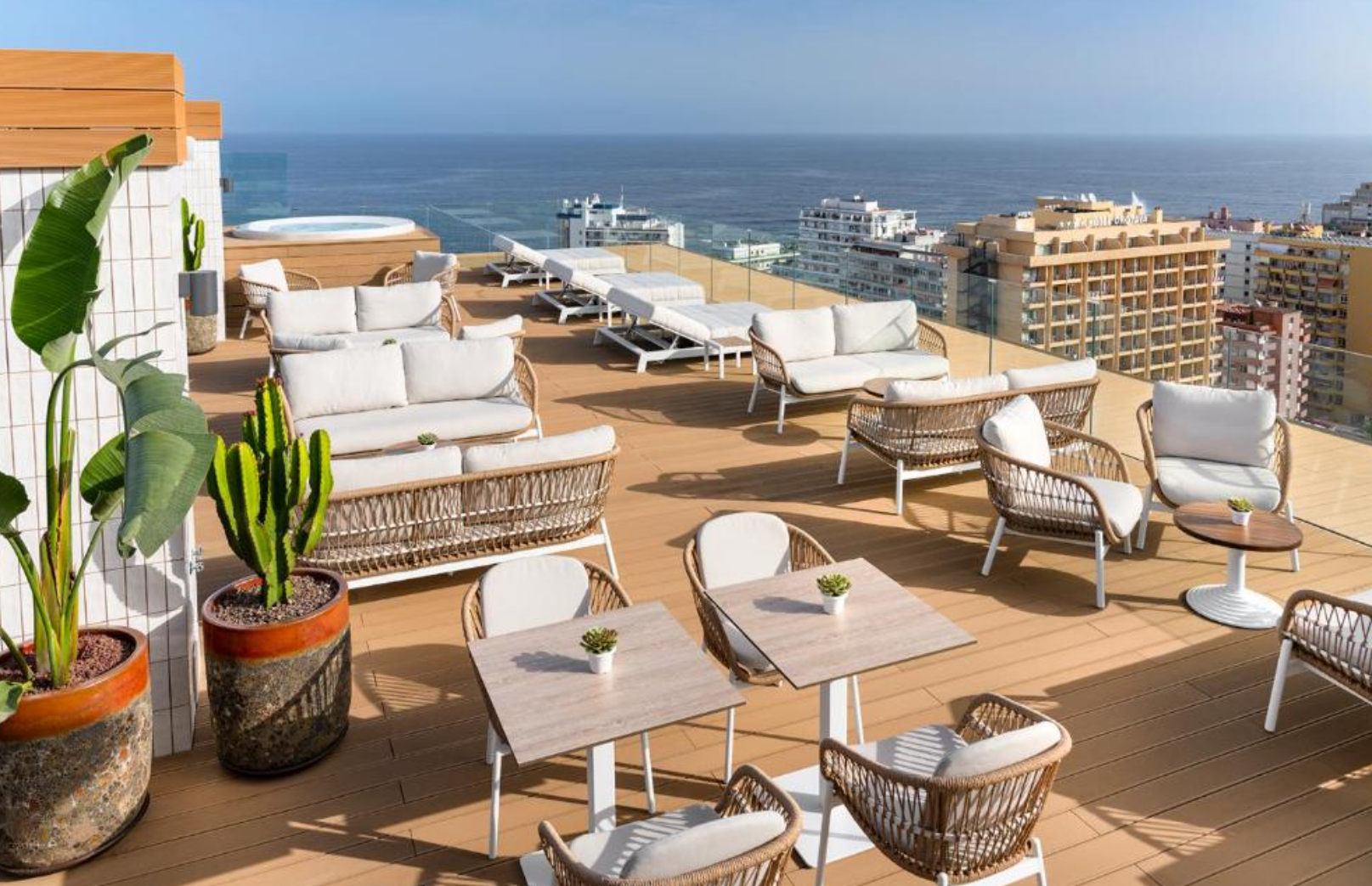 Completed hotel rooftop terrace with transparent glass railings and an open Atlantic Ocean view.